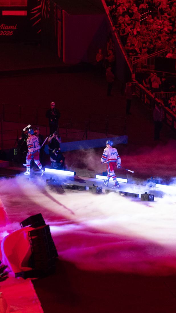 New York Rangers walking out through fog under red light at the Winter Classic