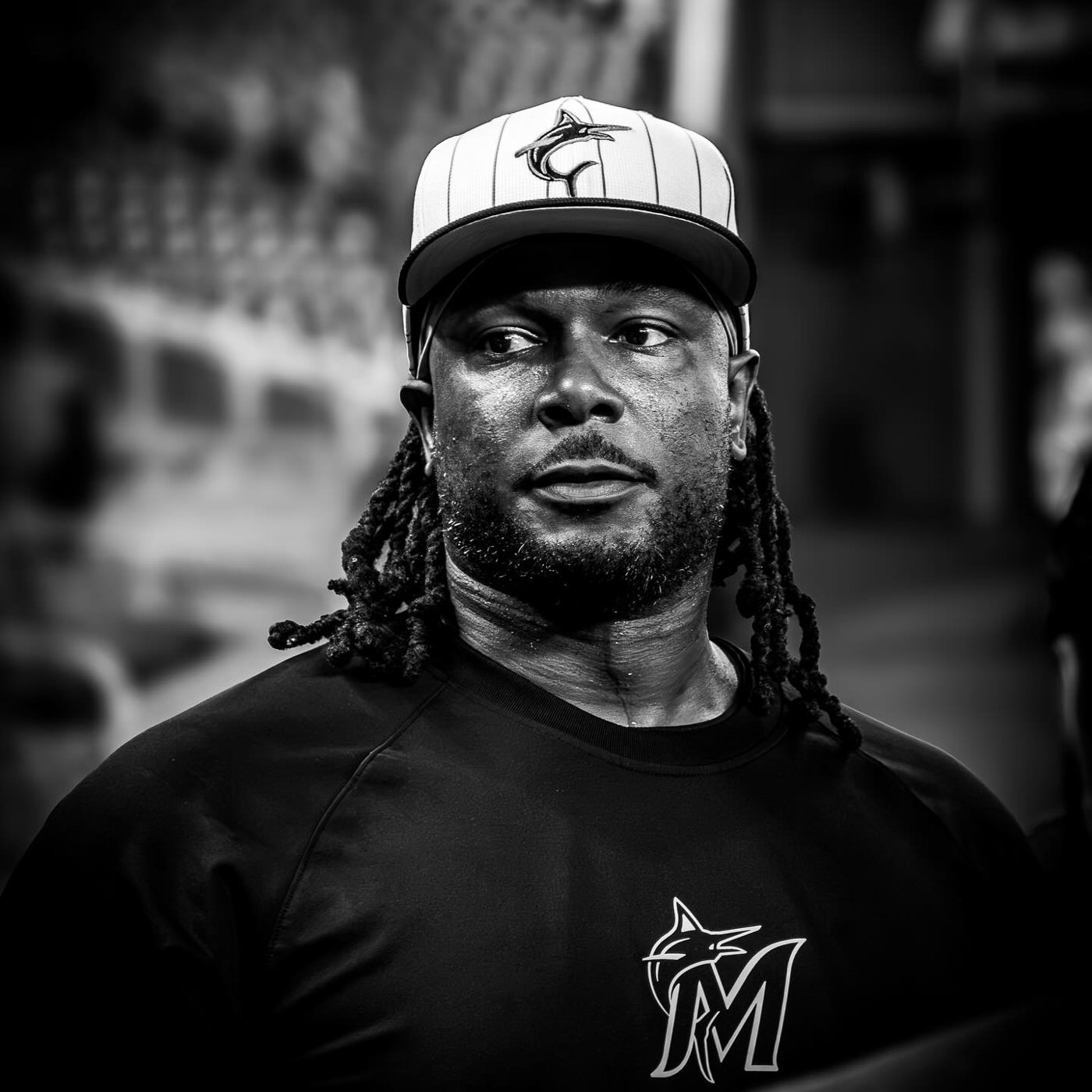 A Marlins coach in black and white wearing a pinstriped cap