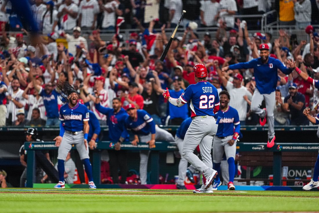 The Dominican Republic dugout erupting as Juan Soto flips his bat