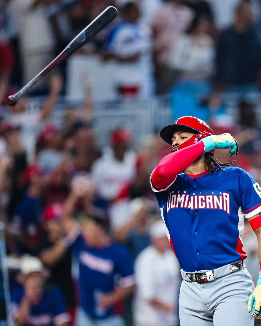 A Dominican Republic hitter flipping his bat after a home run