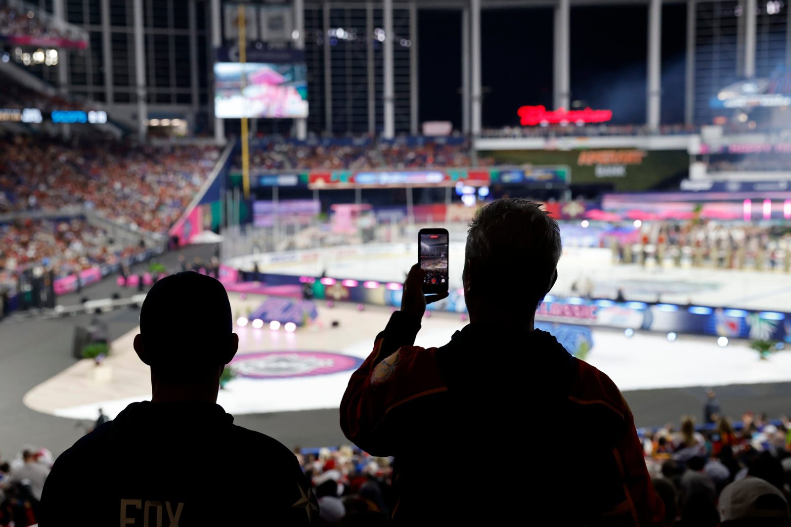 Fans filming the NHL Winter Classic rink inside loanDepot park