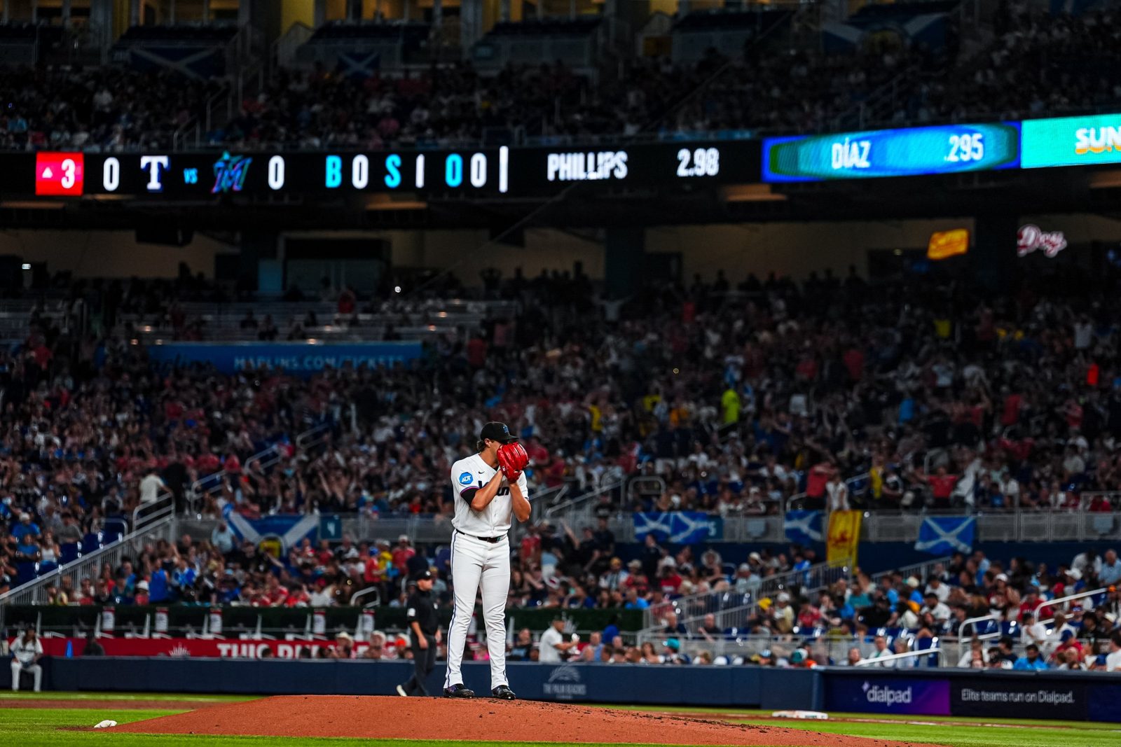 A Marlins pitcher on the mound with Scotland flags in the crowd